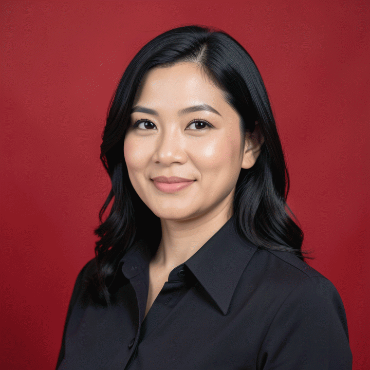 Foto profil formal profesional dengan latar belakang merah solid, menampilkan potret seorang profesional muda Indonesia.